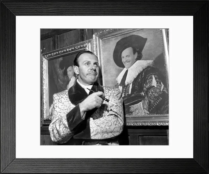 Framed Print : Entertainment: Actor. Terry Thomas in front of a portrait of himself dressed up as Framed Print : Entertainment: Actor. Terry Thomas in front of a portrait of himself dressed up as