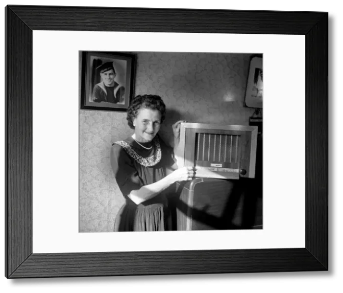 Framed Print : A housewife tunes in her wireless set to The BBC home service. Circa 1953 D6046 Framed Print : A housewife tunes in her wireless set to The BBC home service. Circa 1953 D6046