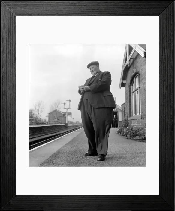 Framed Print : Fat Man John Feathestone seen here buying a ticket at his local railway station Framed Print : Fat Man John Feathestone seen here buying a ticket at his local railway station