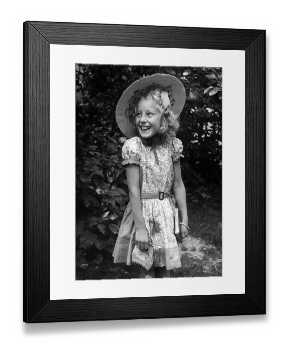 Framed Print : Young girl standing in the back garden wearing a flowery dress Framed Print : Young girl standing in the back garden wearing a flowery dress