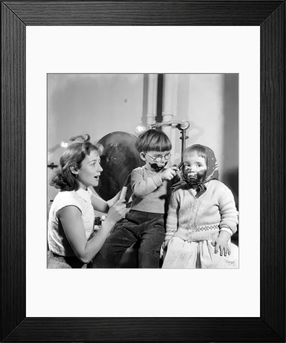 Framed Print : Joe, 4, and Tessa 2, play with the grease paint as their mother Helena Hughes, (Mrs Framed Print : Joe, 4, and Tessa 2, play with the grease paint as their mother Helena Hughes, (Mrs