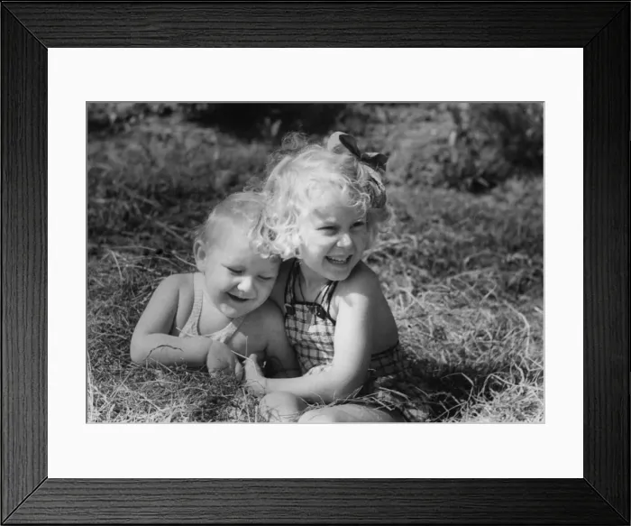 Framed Print : Young boy and girl playing in the grass Circa 1945 P044463