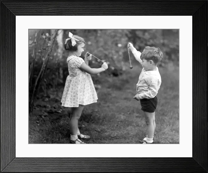 Framed Print : Young girl and boy playing conkers. circa 1945 Framed Print : Young girl and boy playing conkers. circa 1945