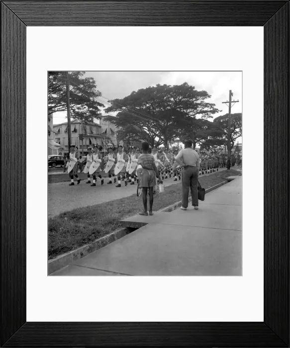 Framed Print : British soldiers marching in Georgetown, British Guiana followed by some children Framed Print : British soldiers marching in Georgetown, British Guiana followed by some children