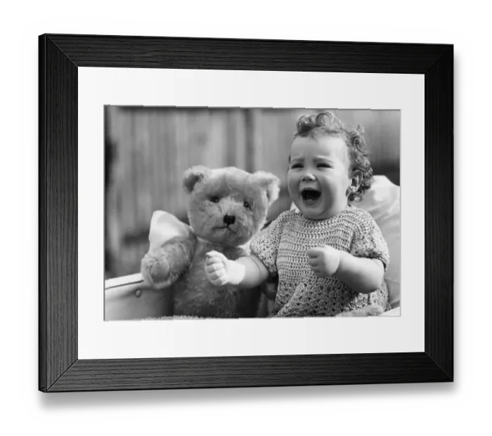 Framed Print : Baby girl in her pram with her teddy bear Circa 1945 P044424