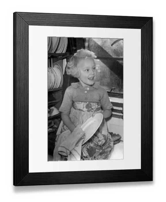 Framed Print : Young girl helping out a home by doing the washing up Circa 1945 P044422 Framed Print : Young girl helping out a home by doing the washing up Circa 1945 P044422