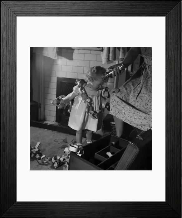 Framed Print : 15 month-old Janice Cook with Christmas chains playing in the living room November
