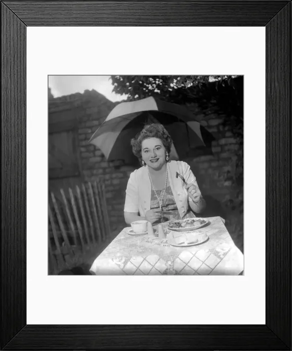 Framed Print : Woman having picnic in the rain. July 1953 D3603