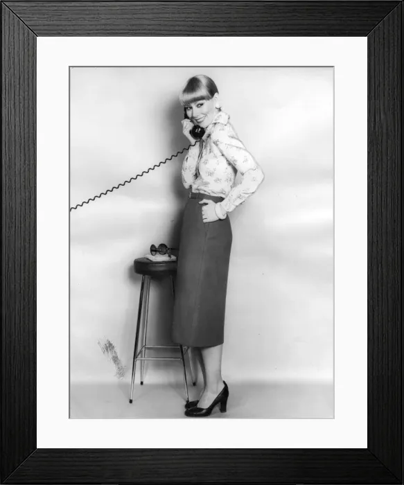 Framed Print : A model talking on the telephone wearing a pencil skirt Framed Print : A model talking on the telephone wearing a pencil skirt