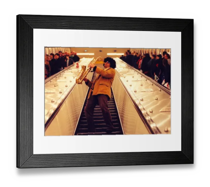 Framed Print : Sax player Jason Tenniswood in a wig entertains travellers at Monument Metro station