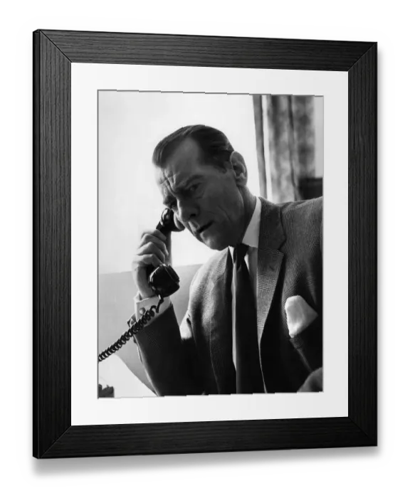 Framed Print : Man having a telephone conversation at his desk. Circa 1960 P009059