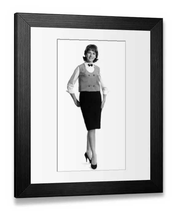 Framed Print : Model Diana Lovell wearing shirt bow tie and waistcoat with knee length skirt Framed Print : Model Diana Lovell wearing shirt bow tie and waistcoat with knee length skirt