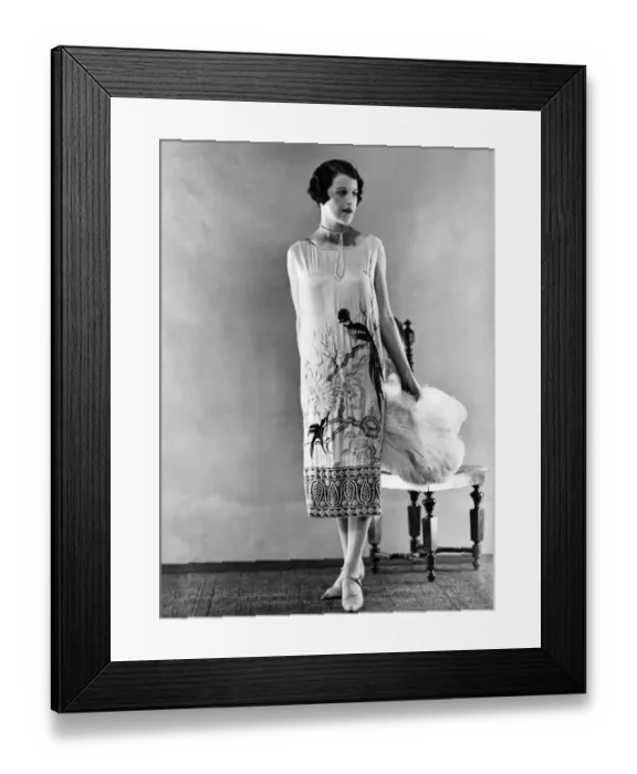 Framed Print : Woman wearing long sleeveless dress with black parrot design at hem Framed Print : Woman wearing long sleeveless dress with black parrot design at hem