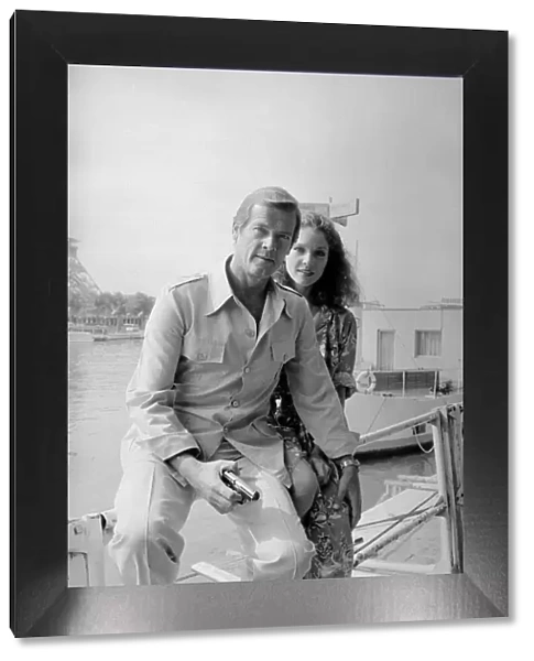 Roger Moore with actress Lois Chiles at a photocall and reception held in Paris to