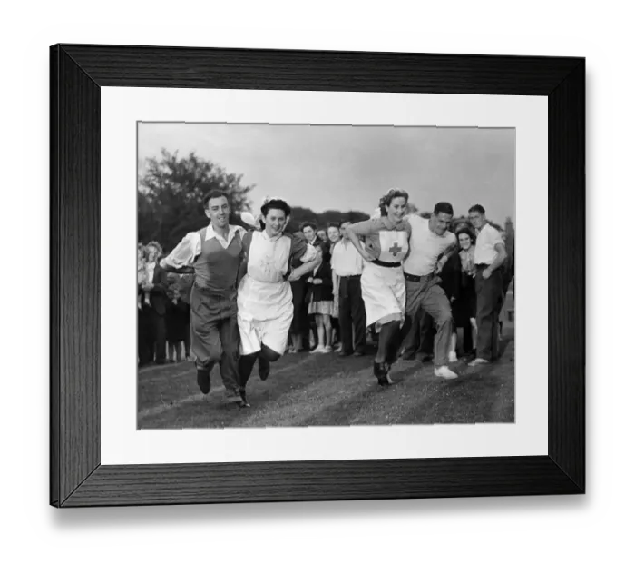 Framed Print : Convalescent soldiers run a three legged race with their nurses at a village sports day Framed Print : Convalescent soldiers run a three legged race with their nurses at a village sports day