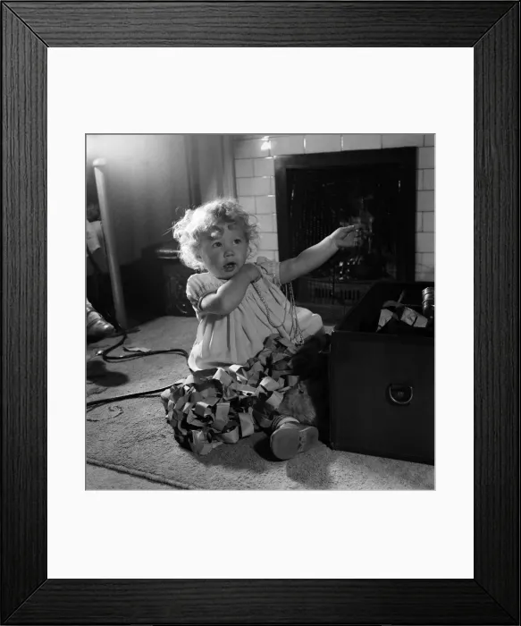 Framed Print : 15 month-old Janice Cook with Christmas chains playing in the living room November Framed Print : 15 month-old Janice Cook with Christmas chains playing in the living room November