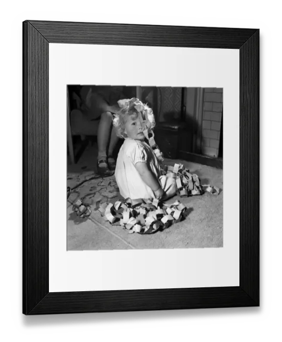 Framed Print : 15 month-old Janice Cook with Christmas chains playing in the living room November Framed Print : 15 month-old Janice Cook with Christmas chains playing in the living room November