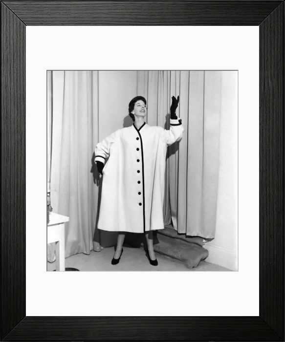 Framed Print : Clothing: Fashion. Model Dorothy Emms wears a white woollen coat with black trim