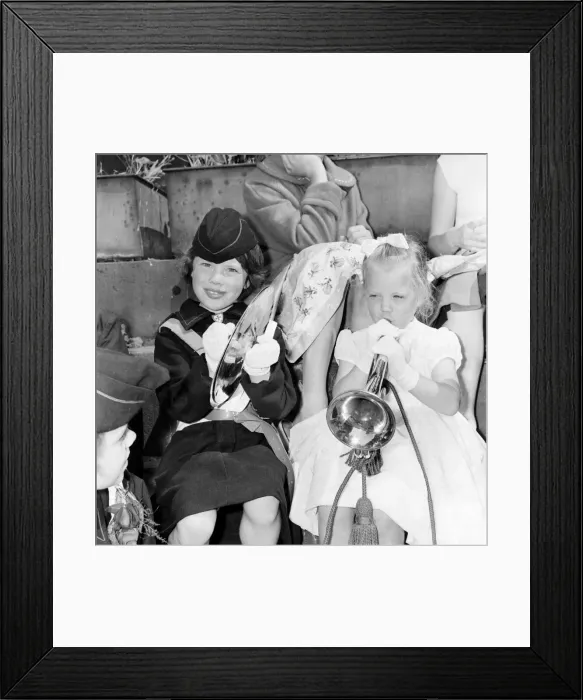 Framed Print : To girls taking part in the Manchester Whit Walks trr their hand at the trumpet Framed Print : To girls taking part in the Manchester Whit Walks trr their hand at the trumpet