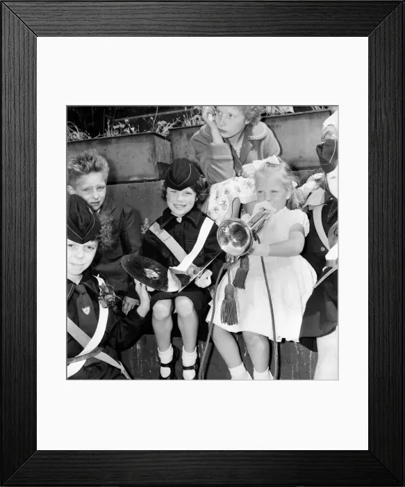 Framed Print : To girls taking part in the Manchester Whit Walks try their hand at the trombone