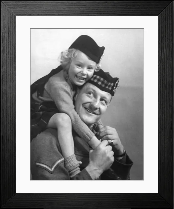 Framed Print : Young girl wearing a hat with tartan design sitting of her fathers shoulder Framed Print : Young girl wearing a hat with tartan design sitting of her fathers shoulder