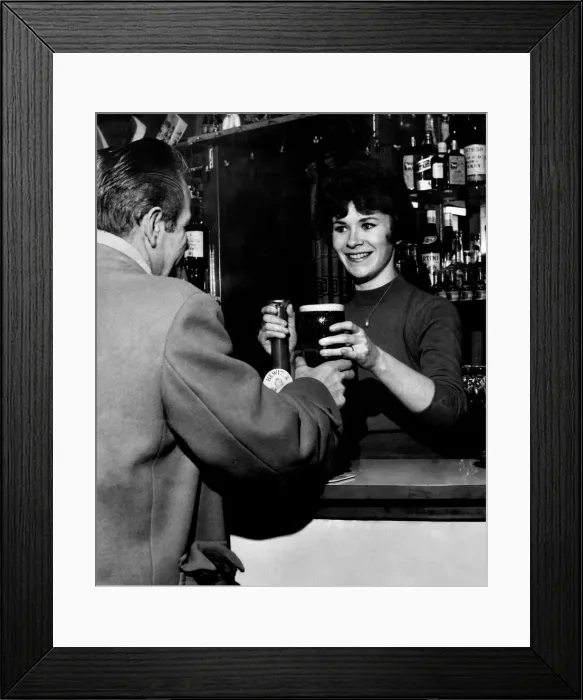 Framed Print : 21 year old barmaid Joyce McKnight serving a customer at the Black Bull Pub in Doncaster Framed Print : 21 year old barmaid Joyce McKnight serving a customer at the Black Bull Pub in Doncaster