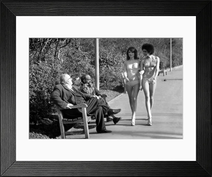 Framed Print : Fashion scene from Woolworth s. Two old men sitting on a park bench distracted by Framed Print : Fashion scene from Woolworth s. Two old men sitting on a park bench distracted by