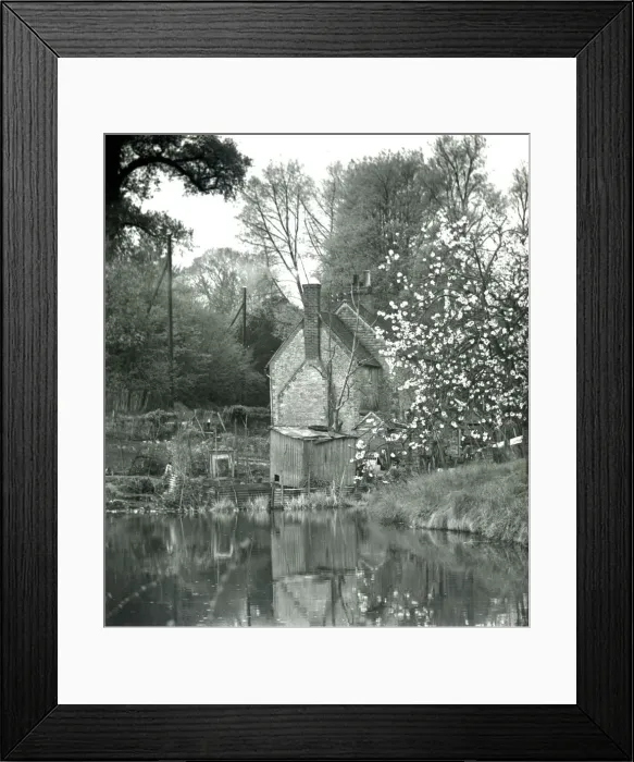 Framed Print : Quaint rural house set on the side of a lake surrounded by fruit tree blossoms Framed Print : Quaint rural house set on the side of a lake surrounded by fruit tree blossoms