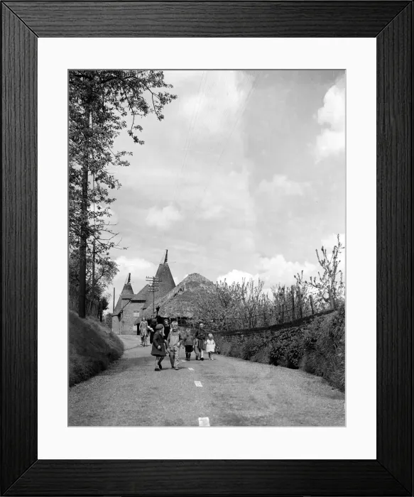 Framed Print : Children walking down a country lane in a typical Kent village