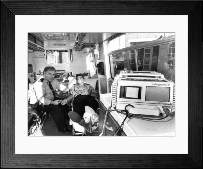 Framed Print : Paramedic Tommy Birdsey demonstrates the latest lifesaving equipment witht the help of