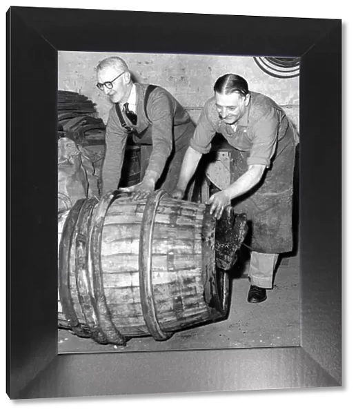 Coppers pushing a finished barrel made by an apprentice to mark the end of his five year