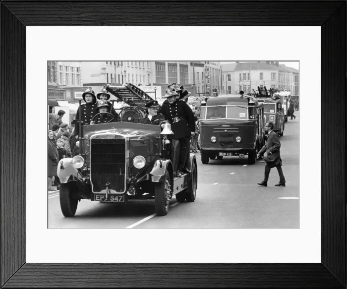 Framed Print : A parade of fire engines past and present - one man appears unimpressed as he tries to Framed Print : A parade of fire engines past and present - one man appears unimpressed as he tries to