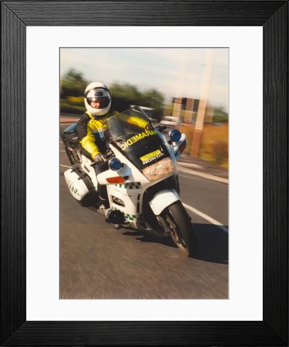 Framed Print : Motorcycle paramedic Chris Kimber on his way to another emergency