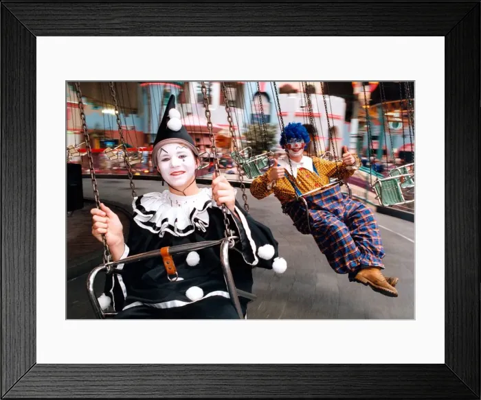 Framed Print : Clowns Matthew Tate and Daren Ridley trying the swings in Metroland Framed Print : Clowns Matthew Tate and Daren Ridley trying the swings in Metroland