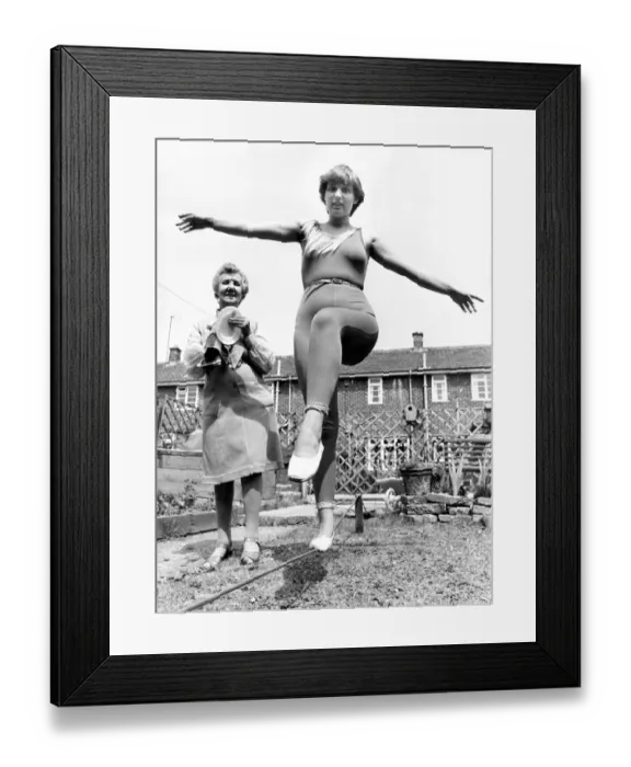 Framed Print : Joanna Curtis practising the tight-rope watched by nana Julia Holtby Framed Print : Joanna Curtis practising the tight-rope watched by nana Julia Holtby