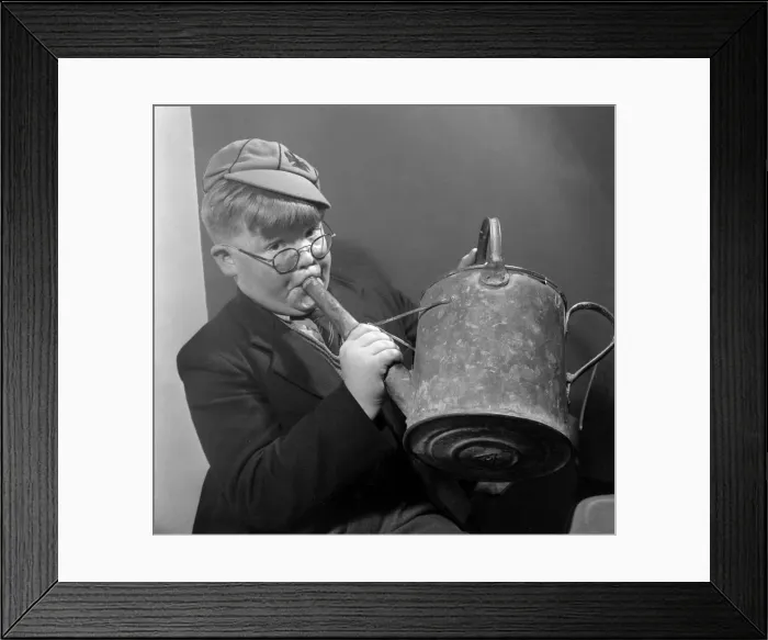 Framed Print : Young schoolboy John Toll tunes up on his watering can before taking part in auditions Framed Print : Young schoolboy John Toll tunes up on his watering can before taking part in auditions