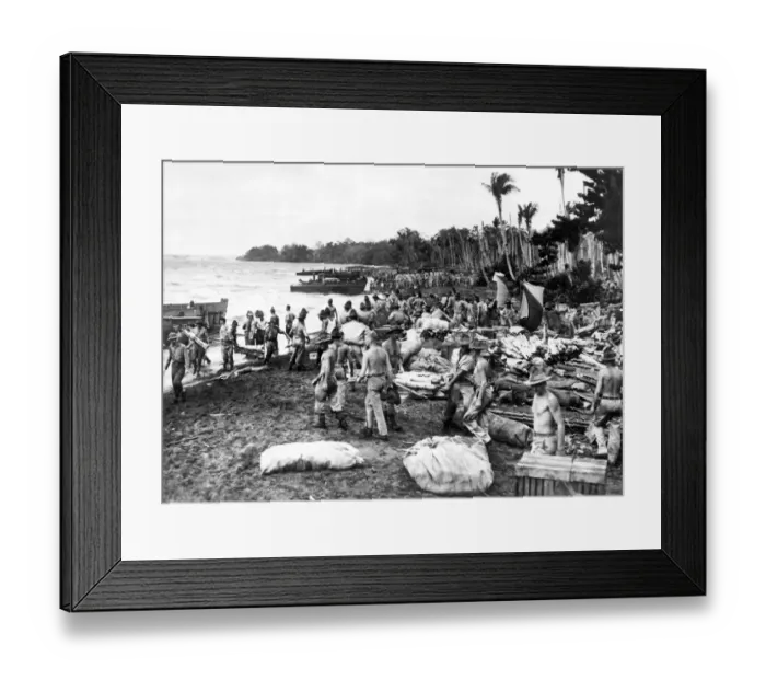 Framed Print : War in the Pacific. Allied soldiers unload supplies and equipment onto the beach of a
