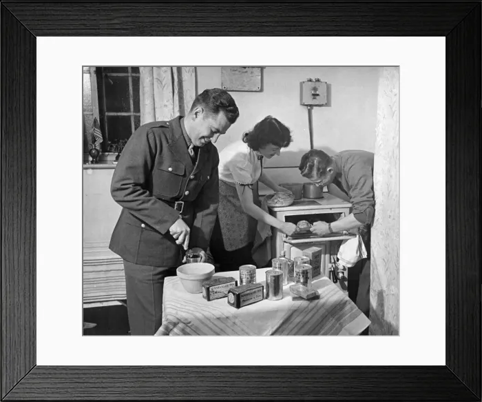 Framed Print : American army troops bring their own food rations to the kitchen of their hostess