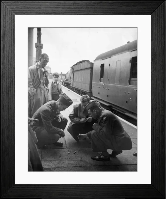Framed Print : American army soldiers while away the time waiting for a train to leave Framed Print : American army soldiers while away the time waiting for a train to leave
