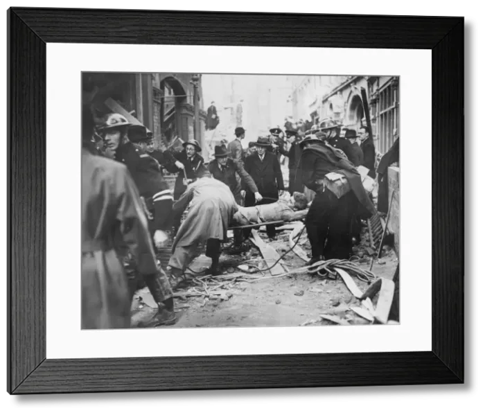 Framed Print : Rescue workers bringing up a soldier victim from an area he was blown into following a Framed Print : Rescue workers bringing up a soldier victim from an area he was blown into following a
