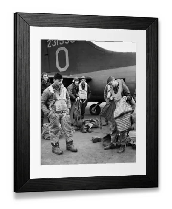 Framed Print : A waist gunner of the American Eighth Army Air Force preparing his armour plated jacket
