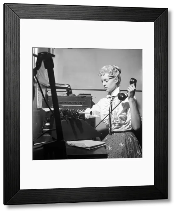 Framed Print : General office scene: Secretary taking notes and answering the phone in a Birmingham Framed Print : General office scene: Secretary taking notes and answering the phone in a Birmingham