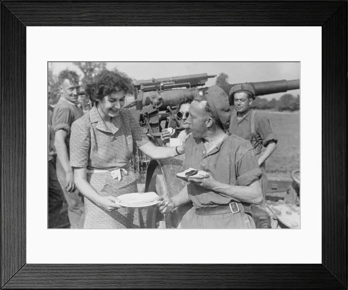 Framed Print : ENSA girl Marjorie Jarvis compliments an artilleryman on his cooking at a base in France Framed Print : ENSA girl Marjorie Jarvis compliments an artilleryman on his cooking at a base in France