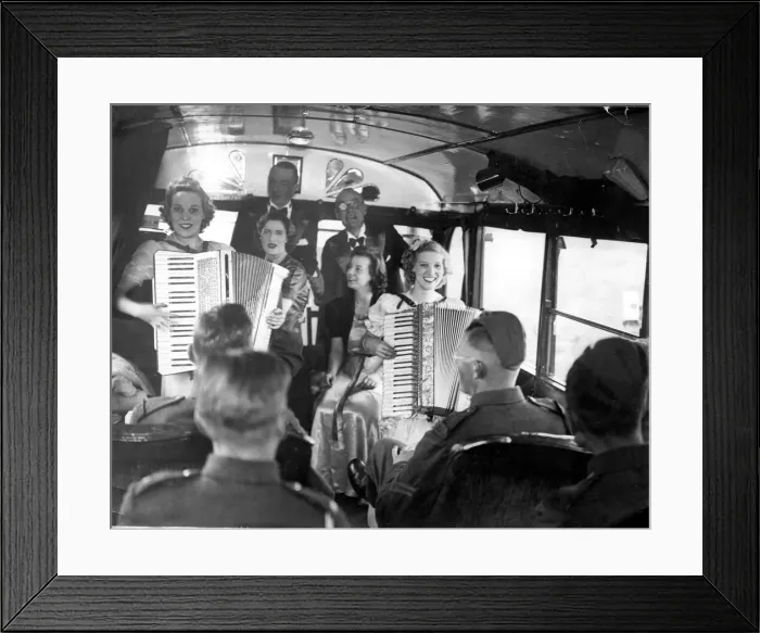 Framed Print : British army soldiers enjoy a performance from girls playing accordions at their mobile