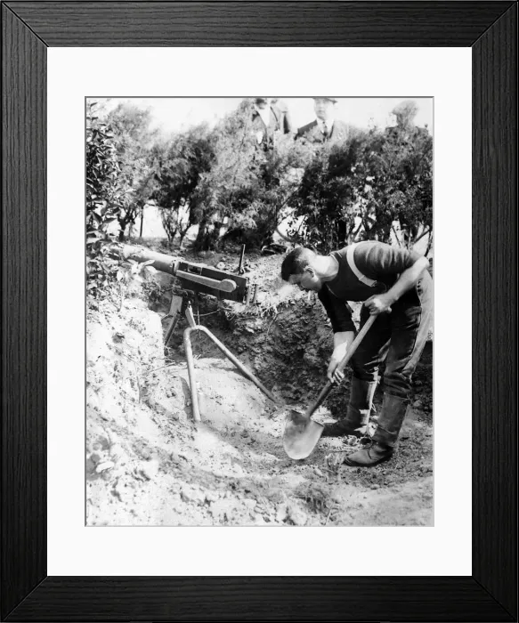 Framed Print : A British Royal Marine seen here digging in a machine gun emplacement close to Framed Print : A British Royal Marine seen here digging in a machine gun emplacement close to