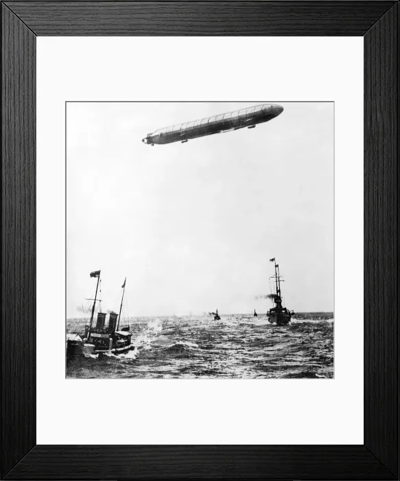 Framed Print : The Zeppelin airship flying over a battleship in the ocean during World War One Framed Print : The Zeppelin airship flying over a battleship in the ocean during World War One