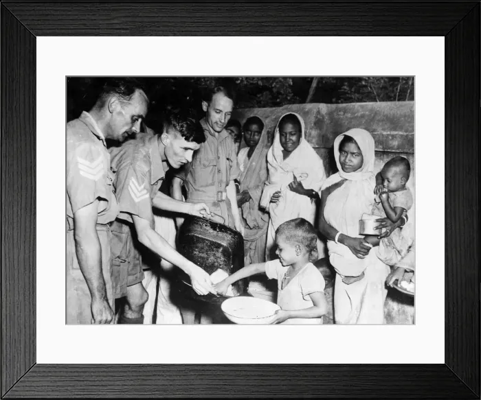 Framed Print : Men of the Royal Air Force feeding local children in tre Indian famine areas at an RAF