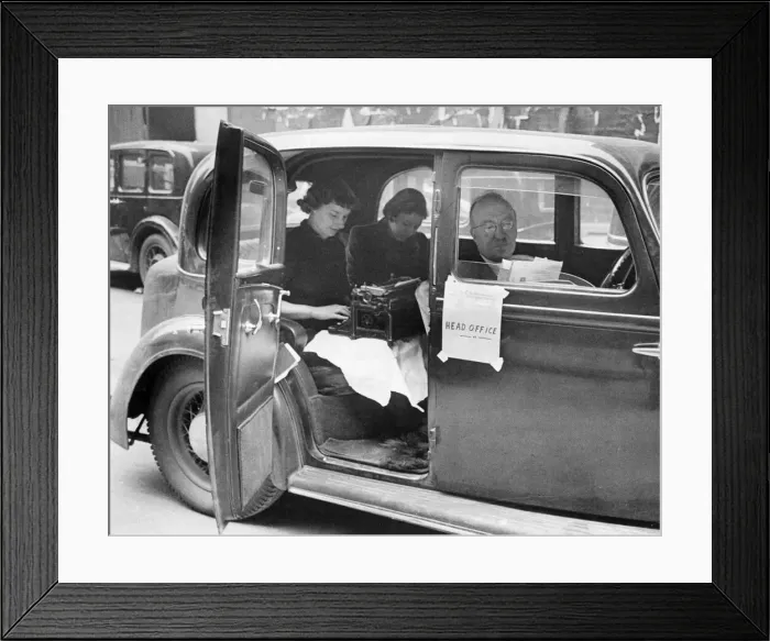Framed Print : Engineering firm receives direct hit. Director of the company sits outside in his car