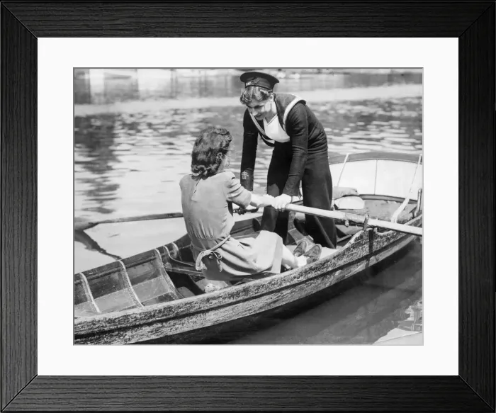 Framed Print : Two young women in a rowing boat, one in Naval uniform, on holiday. 20th May 1945 Framed Print : Two young women in a rowing boat, one in Naval uniform, on holiday. 20th May 1945