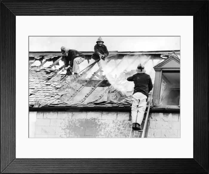 Framed Print : Firefighters clambered over the roofs high above Stockton yesterday to tackle a blaze